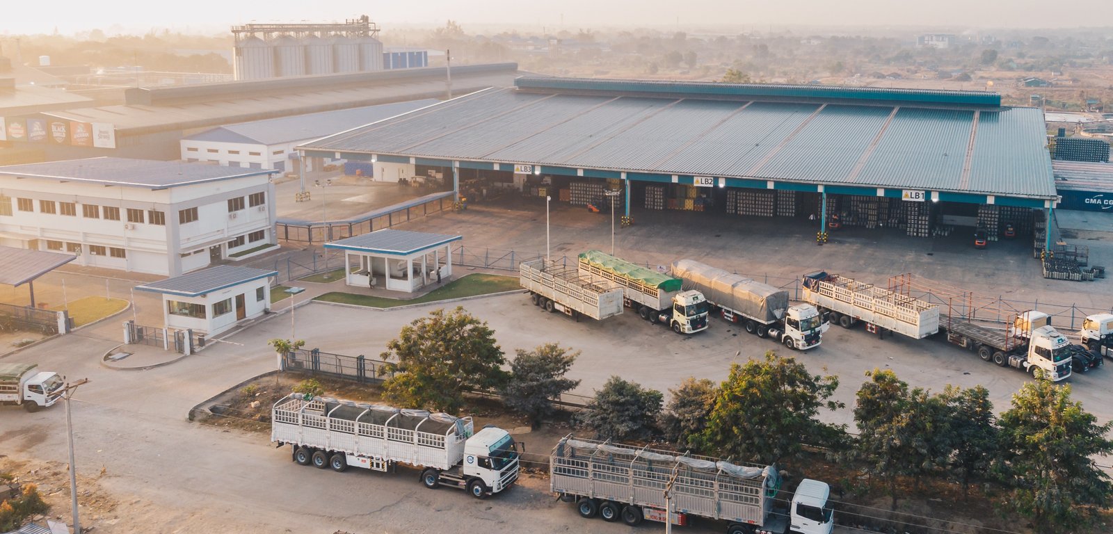 Aerial view factory trucks parked near warehouse